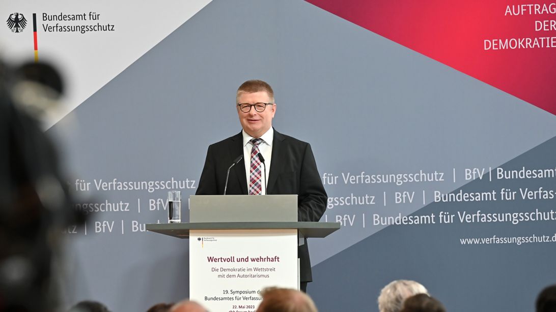 Das Bild zeigt BfV-Präsident Thomas Haldenwang während seiner Rede am Podium des Symposiums.