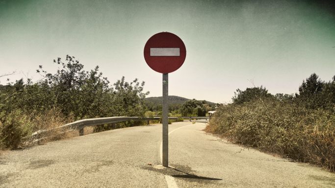 Die Aufnahme zeigt "Einfahrt verboten"-Verkehrsschild mitten auf einer Landstraße (Quelle: Mayte Torres / Moment / Getty Images) Die Aufnahme zeigt "Einfahrt verboten"-Verkehrsschild mitten auf einer Landstraße