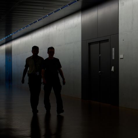 Die Aufnahme vom 25. Juli 2013 zeigt zwei Männer im Schatten auf dem Flur vor dem abhörsicheren Sitzungsaal im Keller des Jakob-Kaiser-Hauses des Bundestags während einer Sondersitzung des Parlamentarischen Kontrollgremiums (PKGr). 