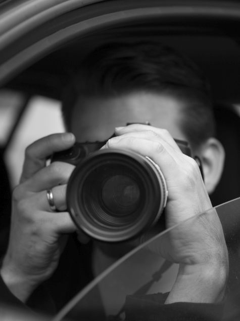 The photo taken on October 5, 2014 shows a man in a car in Berlin photographing something (posed scene)