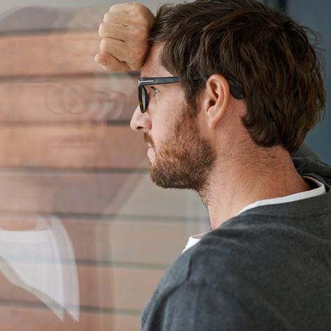 The shot shows a thoughtful young entrepreneur leaning against a window sill in his office (Source: jeffbergen / E+ / Getty Images) The shot shows a thoughtful young entrepreneur leaning against a window sill in his office