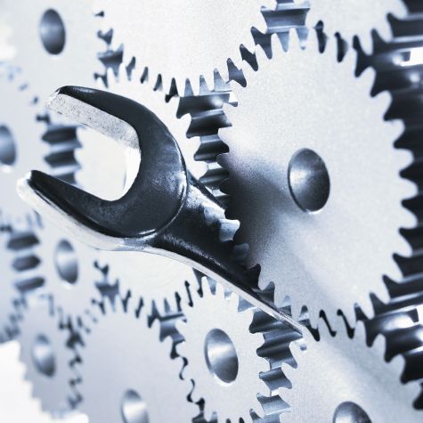 The illustration shows a wrench manipulating a complex work with many gears (Source: Adam Gault / OJO Images / Getty Images) The illustration shows a wrench manipulating a complex work with many gears
