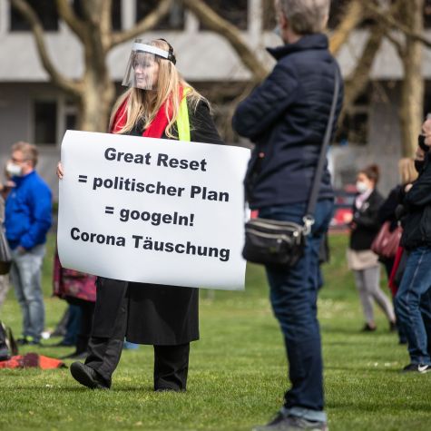 "Great Reset = political plan = google! - Corona deception" is written on the sign of a participant of a demonstration of the initiative "Querdenken". The demonstration is directed against the pandemic restrictions of the federal government.  (Source: picture alliance/dpa | Christoph Schmidt) "Great Reset = political plan = google! - Corona deception" is written on the sign of a participant of a demonstration of the initiative "Querdenken". The demonstration is directed against the pandemic restrictions of the federal government.
