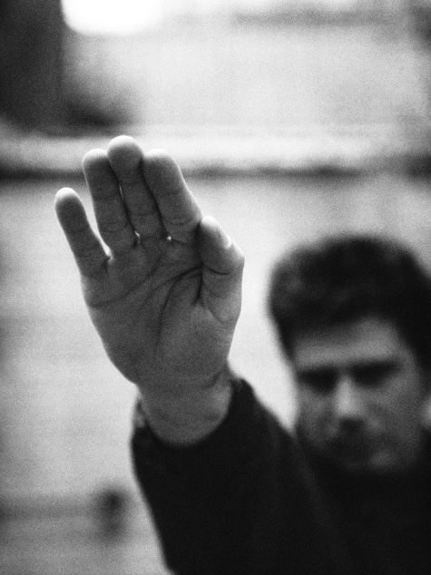 A man stretches his hand up in the air for the Hitler salute.